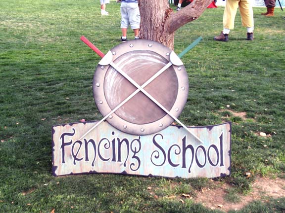 Fencing school sign at Ren Faire. Photo by Rudy Gonzalez.