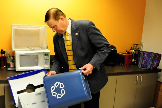 Dr. Glenn E. Mayle recycles his trash.