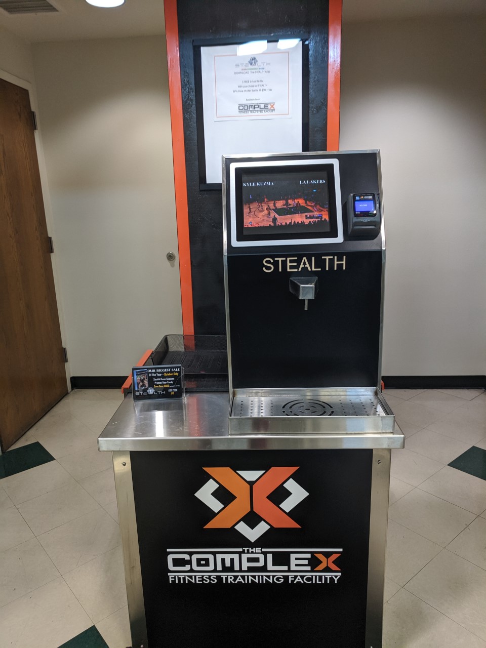 Water dispenser with orange and black colors and the text "Stealth"