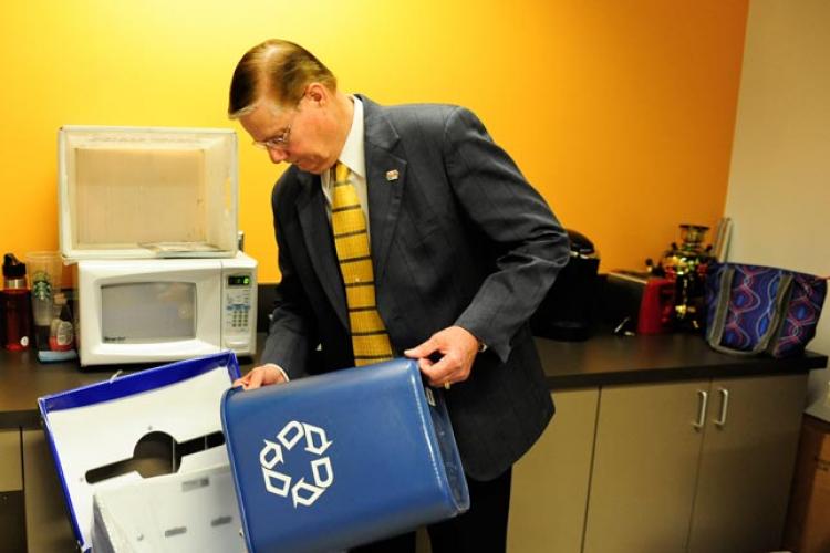Dr. Glenn E. Mayle recycles his trash.