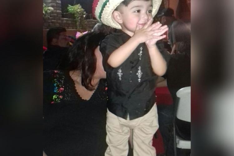 A child participates in the festivities on Mexico's Independence Day. image of a boy in a Mexican-themed hat