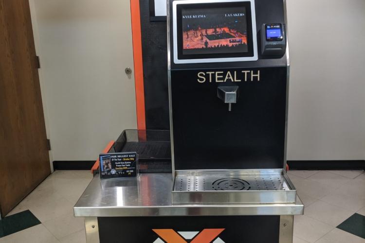 Water dispenser with orange and black colors and the text "Stealth"