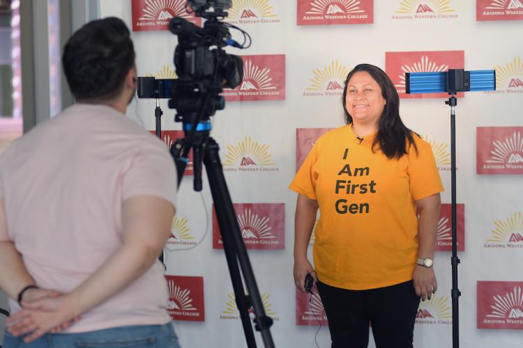 Girl in front of a camera while a man is behind the camera