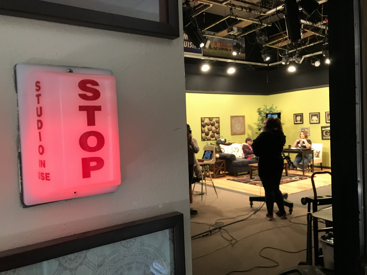 A red STOP light is on, indicating the studio in front is recording